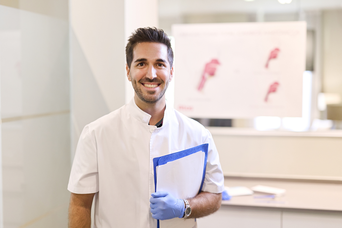 healthcare professional talks to tracheostomy patient in office