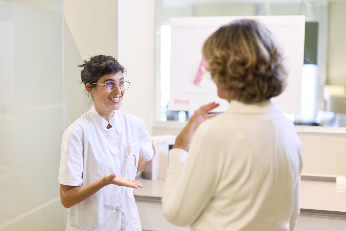 laryngectomy patient taking to healthcare professional in office