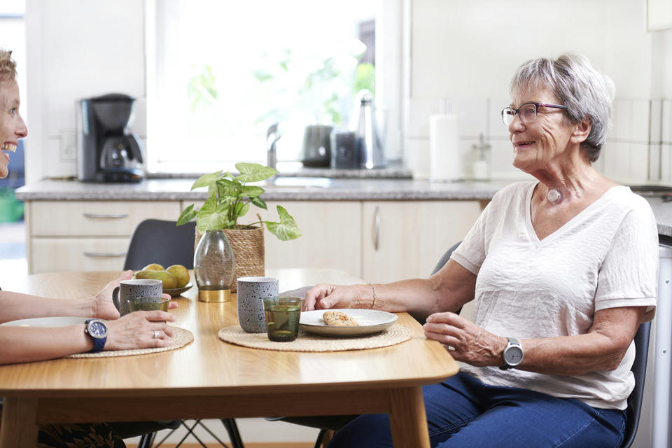 woman using provox life home hme eating in kitchen